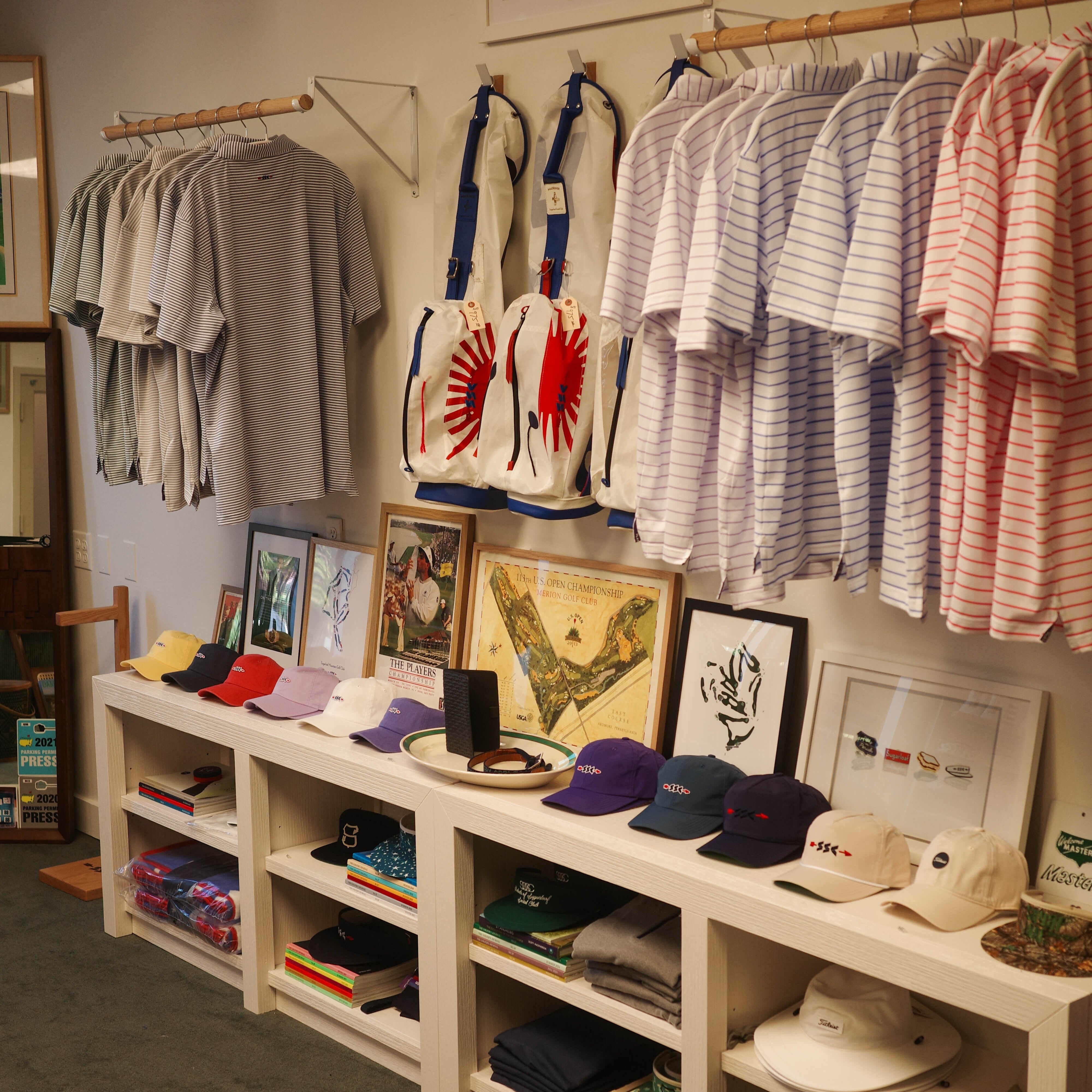 Display of clothing and accessories in a store with shelves and racks.