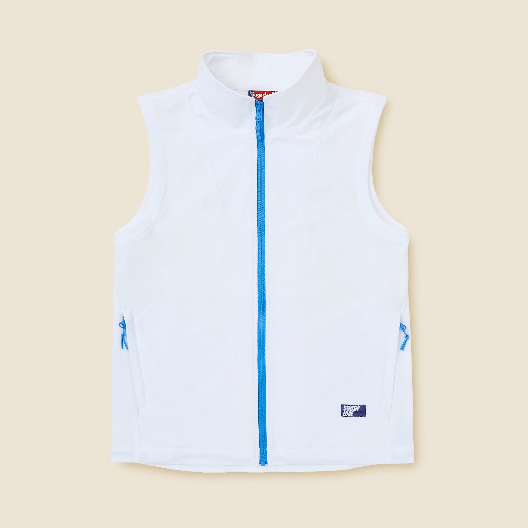 White vest with blue zipper and accents on a beige background