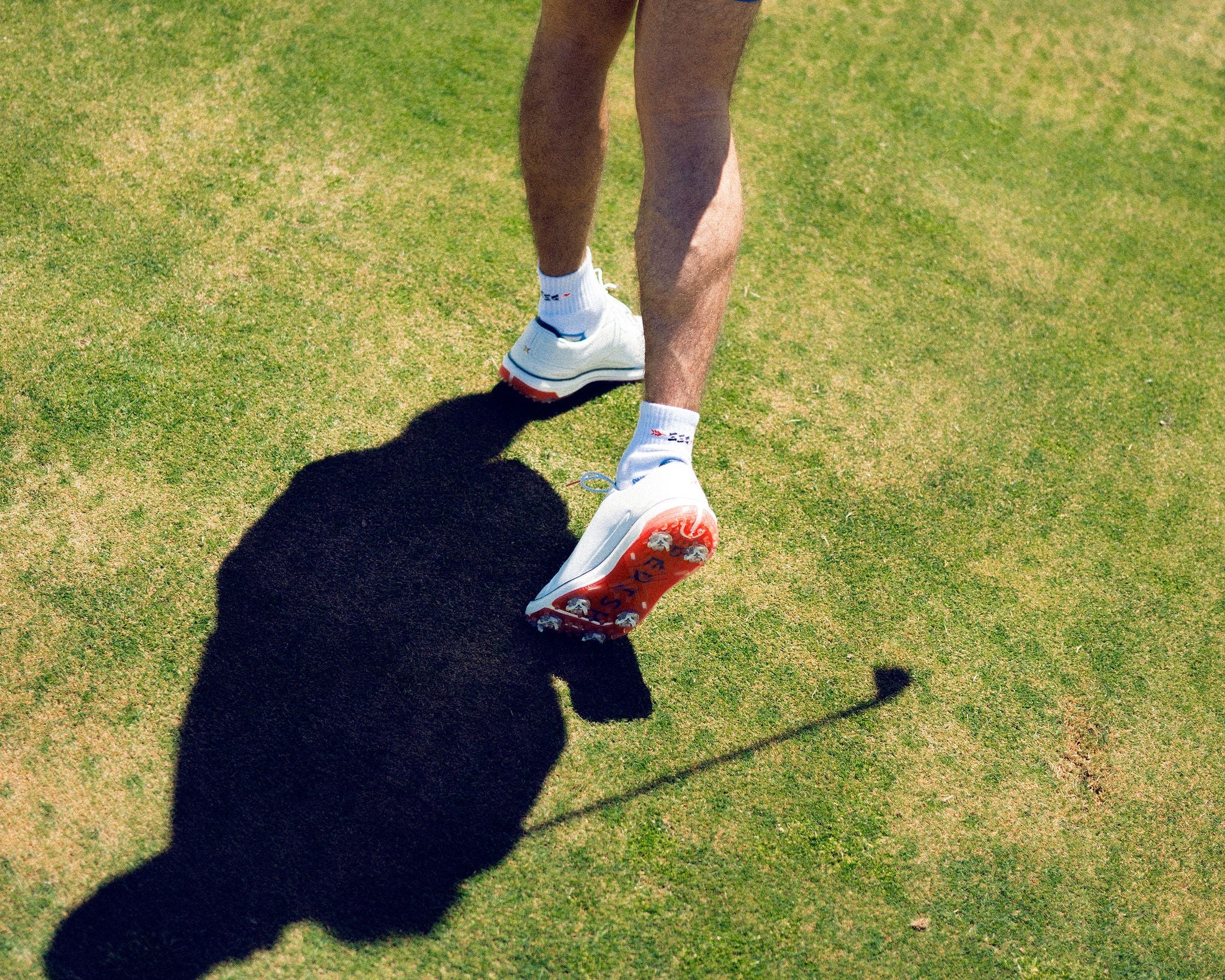 Person playing golf on a grassy field